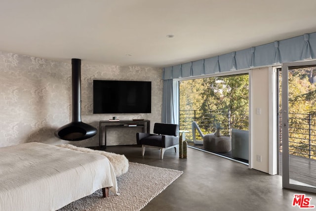 bedroom featuring concrete flooring and access to outside