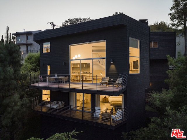 rear view of house featuring a balcony