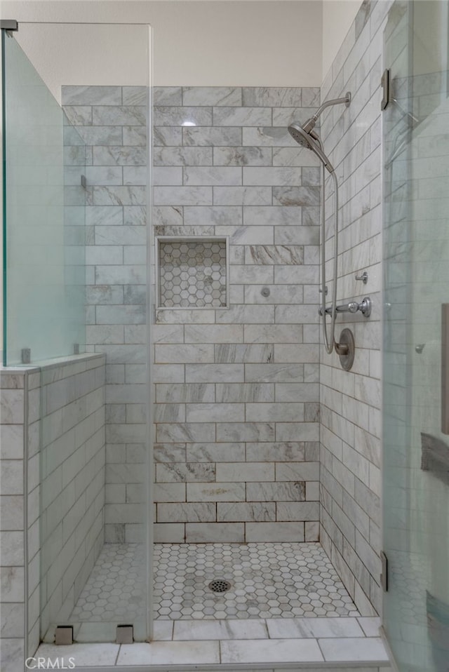 bathroom featuring a shower with door