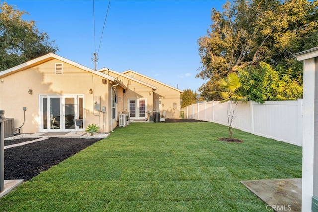 back of house with a lawn, ac unit, and french doors