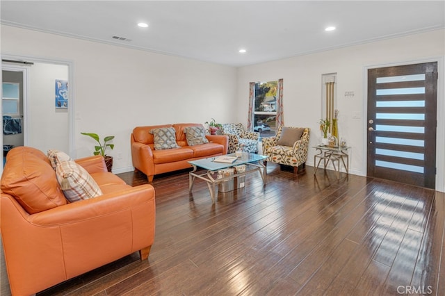 living room with dark wood-type flooring and ornamental molding