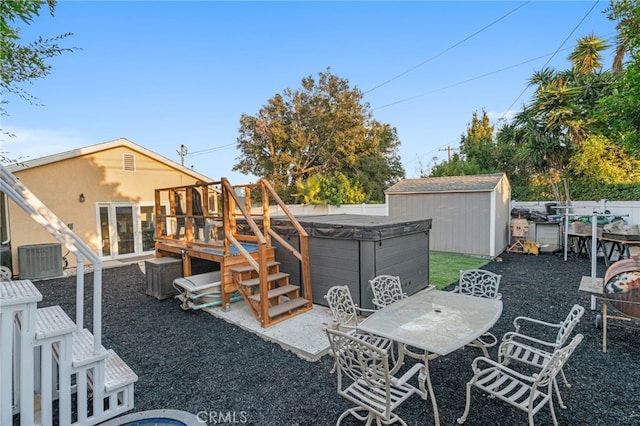 view of yard featuring central AC, a patio area, a shed, and a hot tub