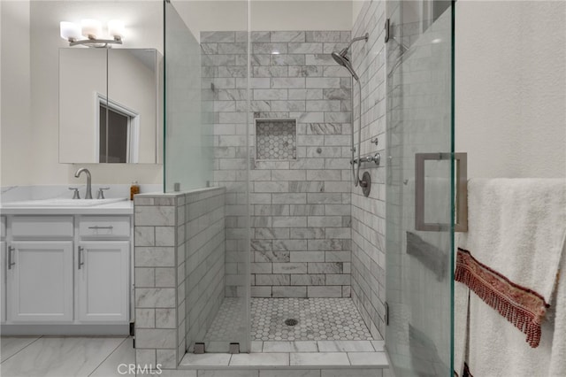 bathroom featuring vanity and a shower with door