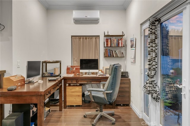 office area with light hardwood / wood-style flooring, an AC wall unit, and crown molding