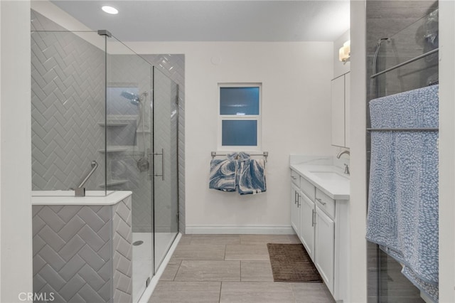 bathroom featuring vanity and an enclosed shower