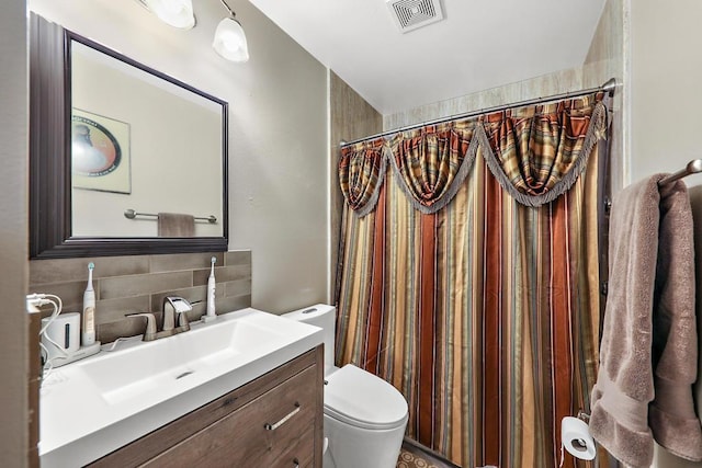 bathroom with decorative backsplash, curtained shower, toilet, and vanity