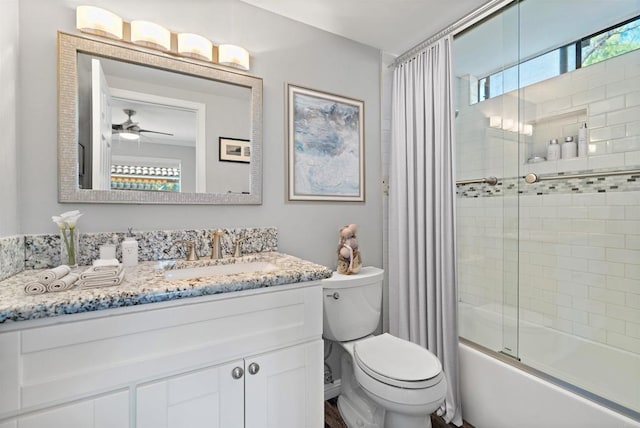 full bathroom featuring toilet, ceiling fan, combined bath / shower with glass door, and vanity