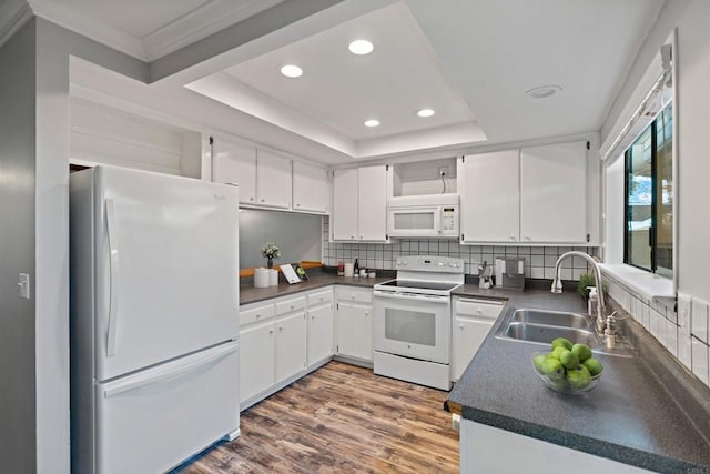 kitchen with white cabinets, white appliances, and dark wood-type flooring