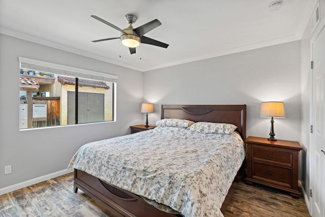 bedroom with crown molding, ceiling fan, and dark wood-type flooring