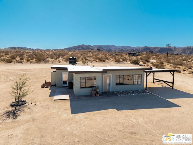 view of front facade featuring a mountain view and a patio area