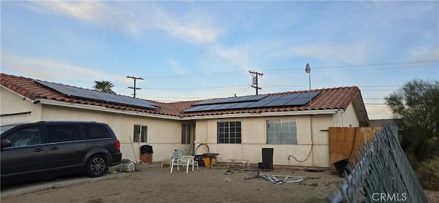 back of house with solar panels