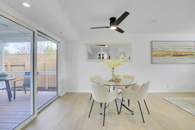 dining space with ceiling fan and light hardwood / wood-style flooring