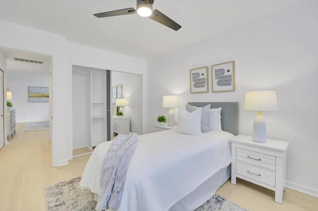 bedroom with ceiling fan, light hardwood / wood-style flooring, and a closet