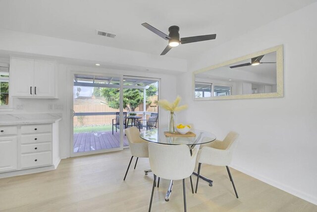 dining area with ceiling fan and light hardwood / wood-style flooring