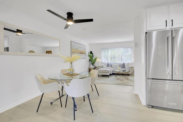 dining area with ceiling fan and light wood-type flooring