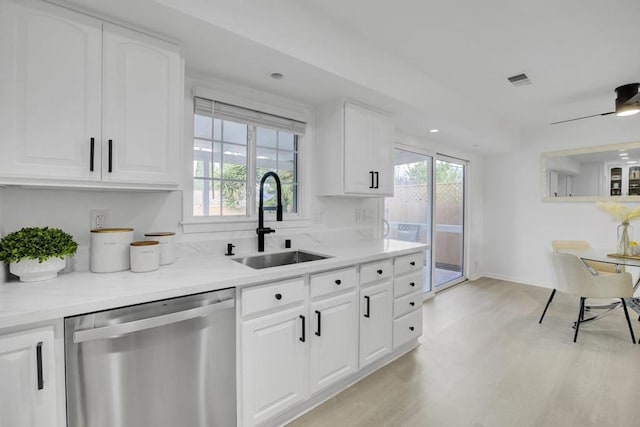 kitchen featuring white cabinets, dishwasher, light wood-type flooring, ceiling fan, and sink