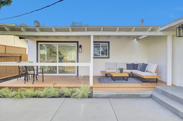 property entrance featuring a deck and an outdoor living space