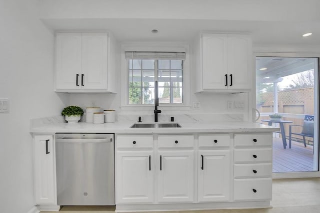 kitchen with sink, white cabinets, dishwasher, and light stone countertops