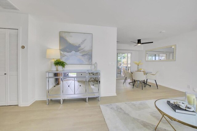 living room with hardwood / wood-style flooring and ceiling fan