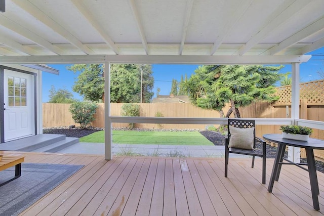 wooden terrace featuring a yard