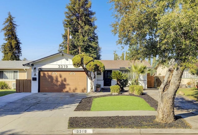 ranch-style home with a front lawn and a garage