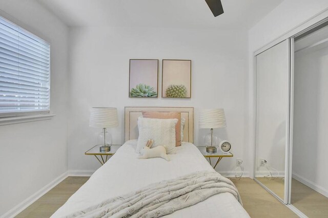 bedroom with ceiling fan, a closet, and hardwood / wood-style floors