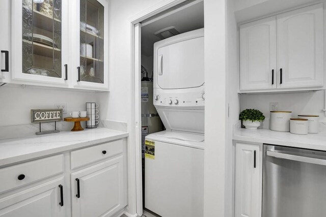 washroom featuring stacked washer and clothes dryer