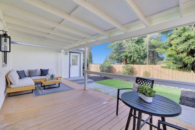 wooden terrace with a lawn and an outdoor living space