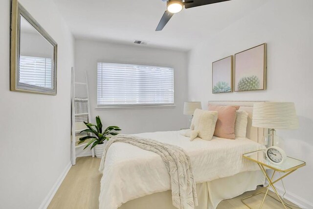 bedroom with ceiling fan and light hardwood / wood-style floors