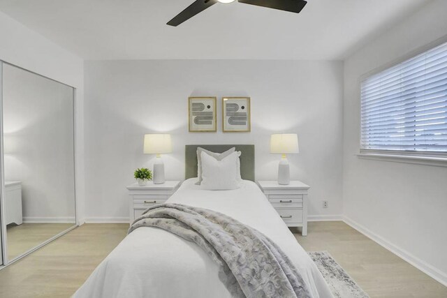 bedroom featuring a closet, ceiling fan, and light wood-type flooring