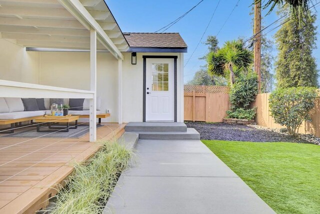 property entrance with a lawn, an outdoor hangout area, and a patio