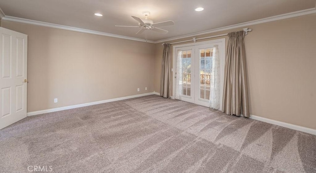 carpeted spare room with ceiling fan and ornamental molding