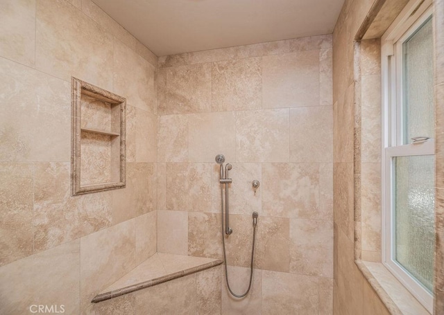 bathroom with tiled shower