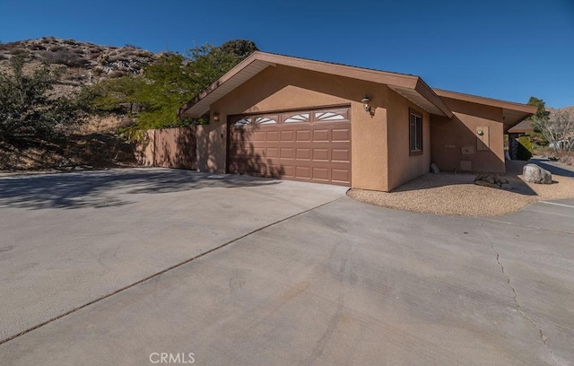 view of side of home featuring a garage