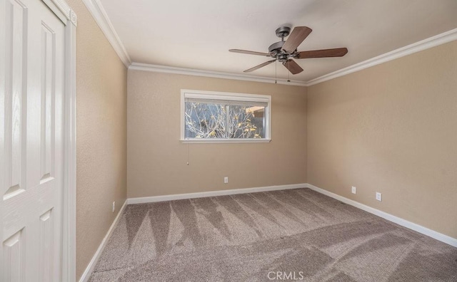 carpeted empty room featuring crown molding and ceiling fan