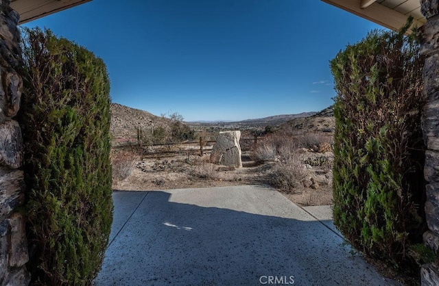 view of yard featuring a mountain view and a patio