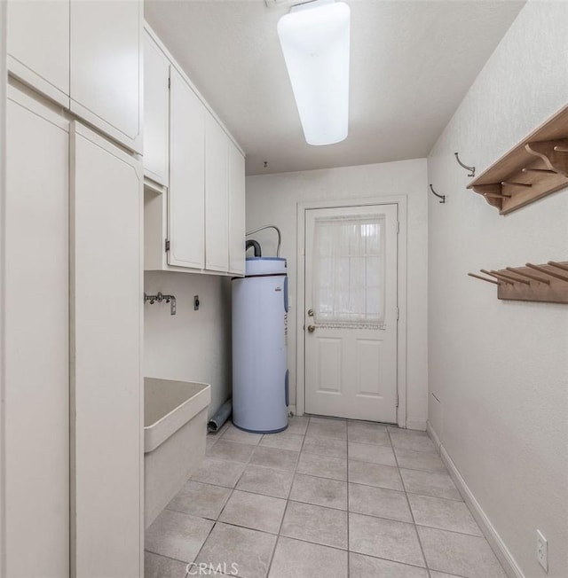 laundry room featuring cabinets, light tile patterned floors, electric dryer hookup, and water heater