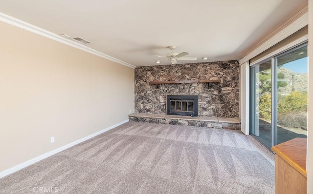 unfurnished living room with carpet floors, crown molding, a fireplace, and ceiling fan