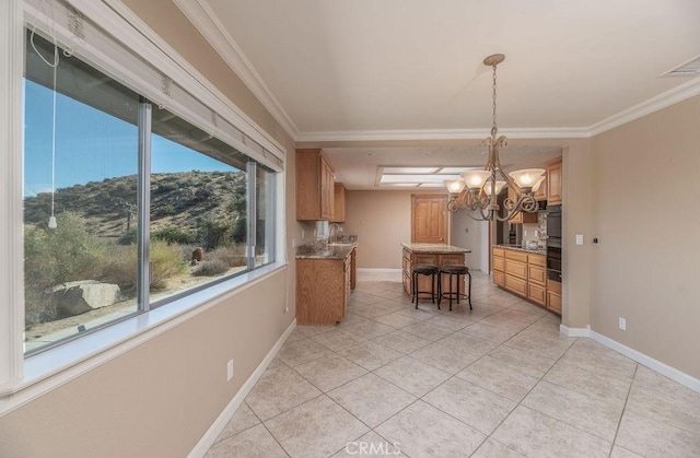 unfurnished dining area with a mountain view, an inviting chandelier, light tile patterned floors, and ornamental molding