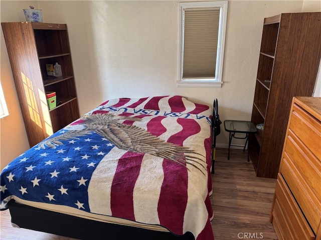 bedroom featuring dark wood-type flooring