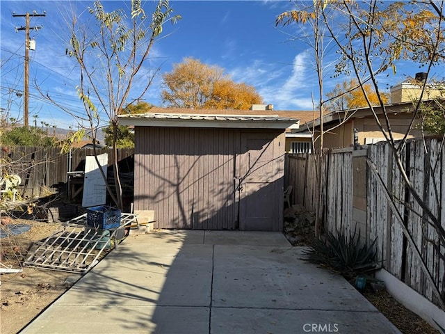 view of property exterior featuring a storage shed