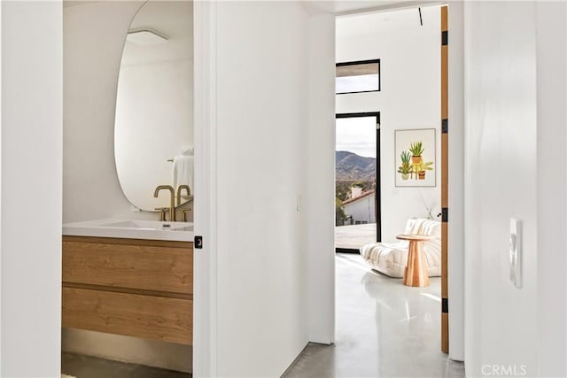 bathroom with concrete flooring, a mountain view, and vanity