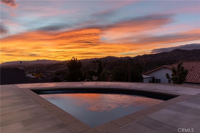 pool at dusk with a mountain view