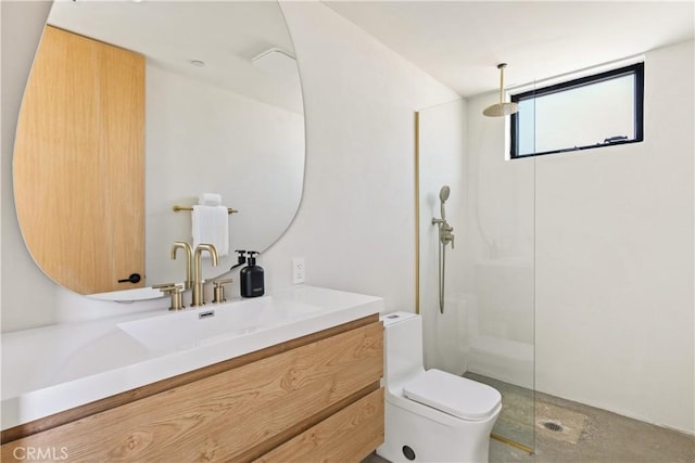 bathroom featuring a shower, vanity, and toilet