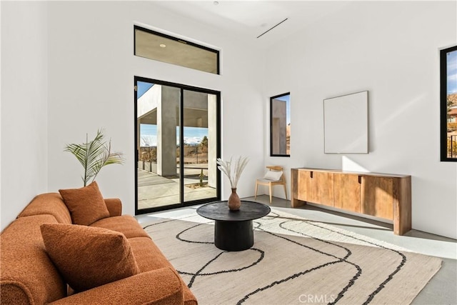 living area with light hardwood / wood-style floors and a healthy amount of sunlight