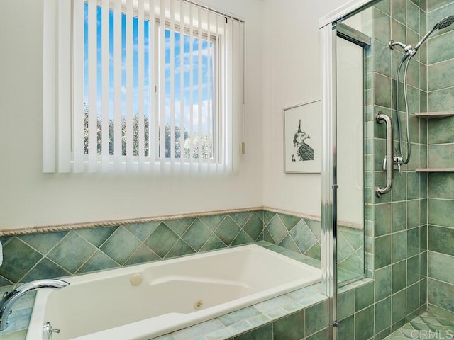 bathroom with a stall shower and a bath