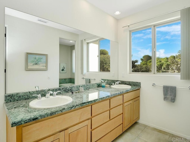 full bath with tile patterned flooring, visible vents, a sink, and double vanity