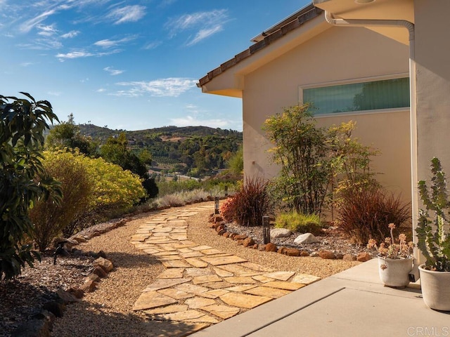 view of home's exterior featuring a mountain view and stucco siding