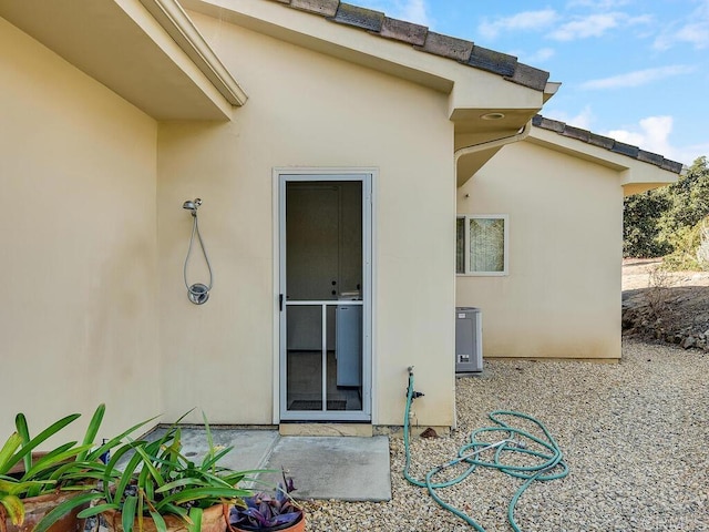 doorway to property featuring a patio area and stucco siding