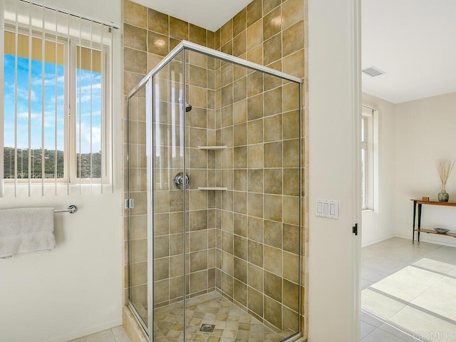 bathroom with tile patterned flooring, visible vents, and a shower stall